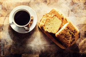 Mug of coffee and slice of cake from overhead view